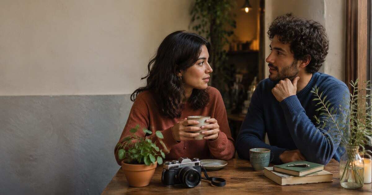 A couple comparing notes and talking during a relaxed coffee date